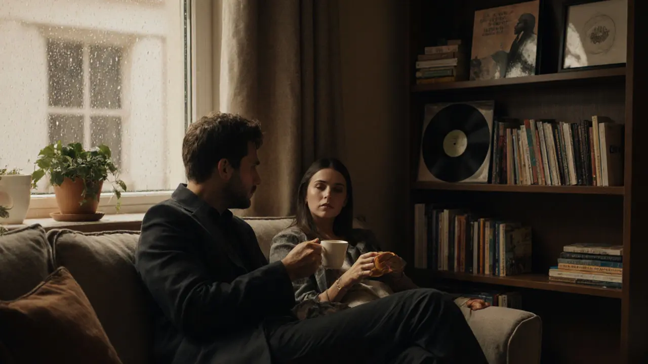 Two people sit comfortably in a London apartment, sharing tea and quiet conversation under soft natural light.