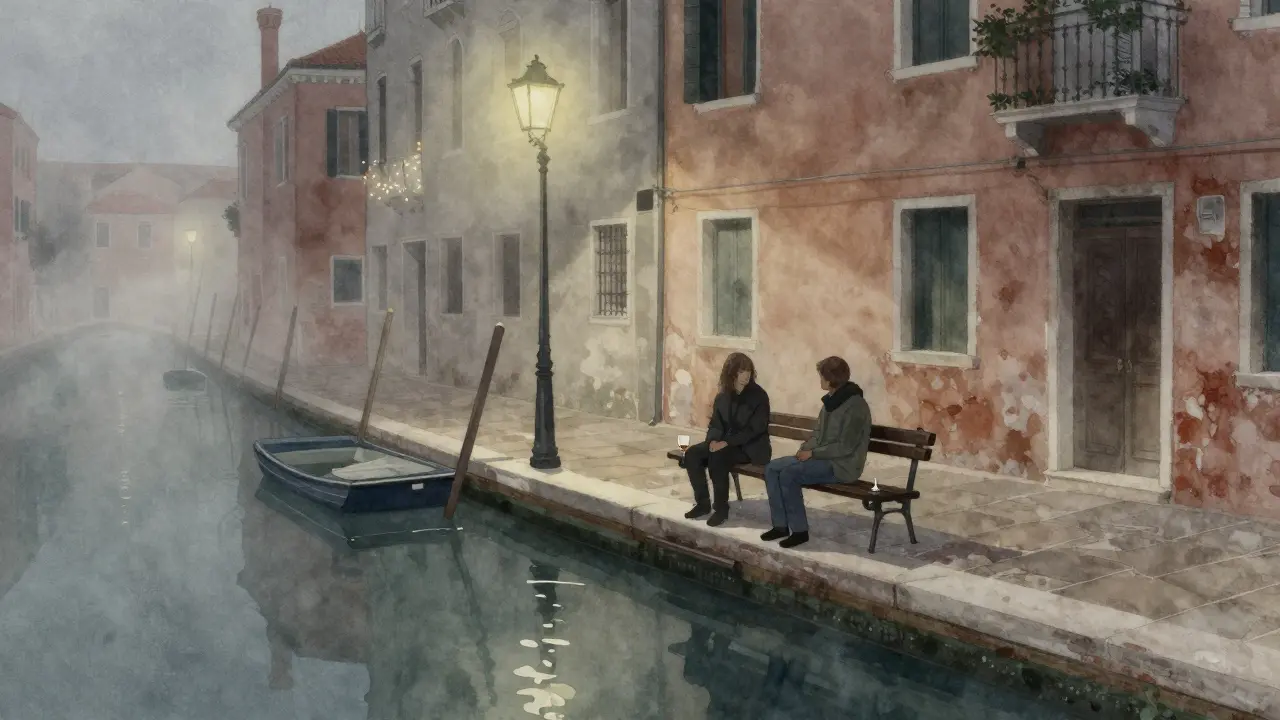 Silhouetted figures on a bench by a foggy Milan canal at night, grappa glass beside them.